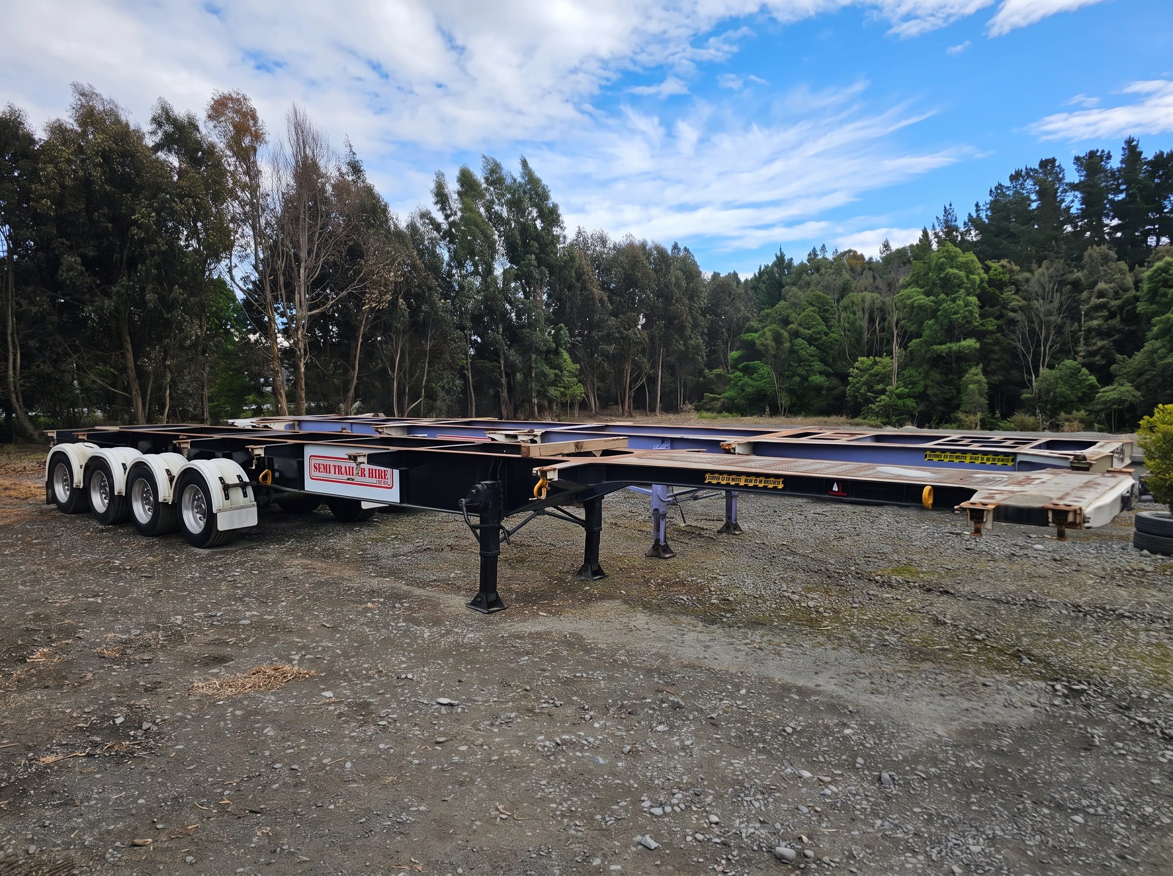 Black quad-axle skeleton trailer